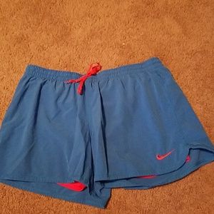Women's blue and orange Nike running shorts